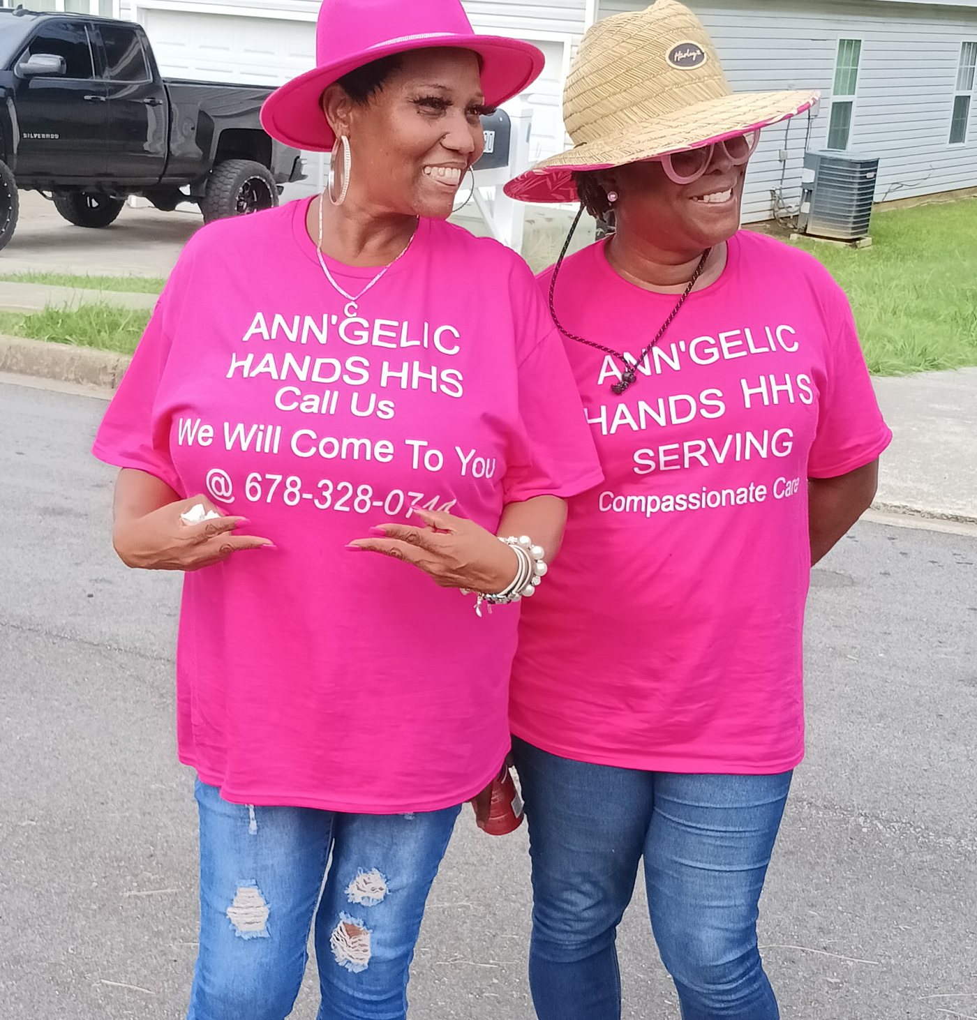 Two women of Ann'gelic Hands side by side in their pink shirts